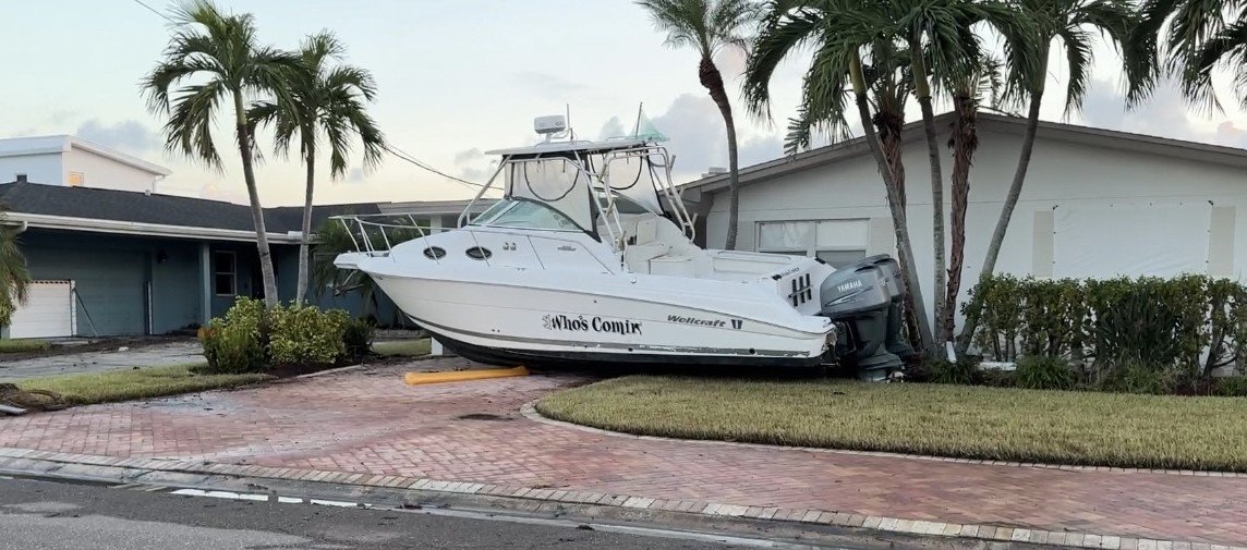 After the hurricane - Storm surge washed boat up on to peoples houses in the community